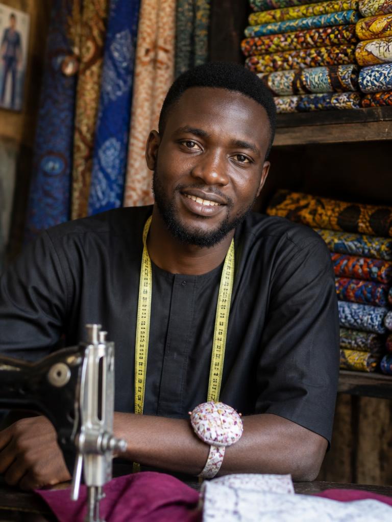 Portrait of a Nigerian tailor in his workshop