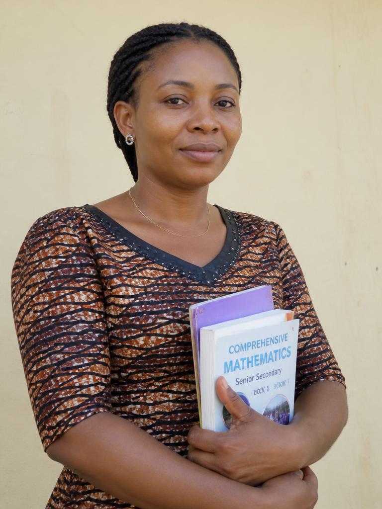 Portrait of a Nigerian teacher holding books